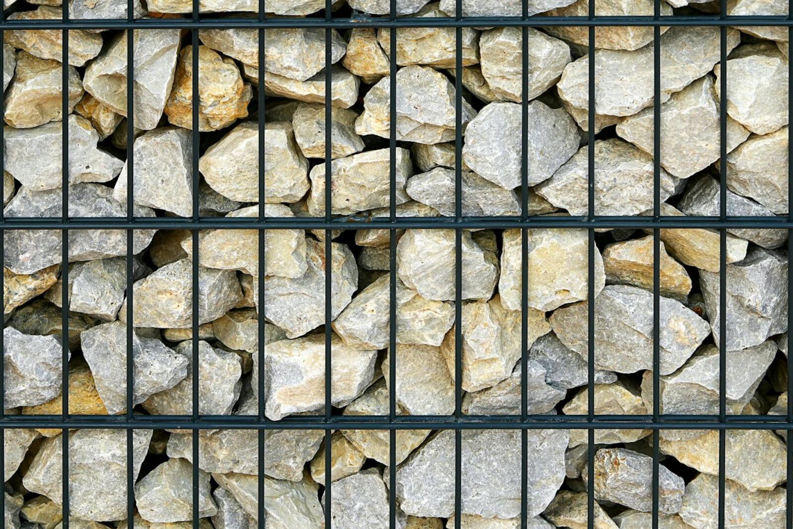 Gabion wall filled with light-colored rocks